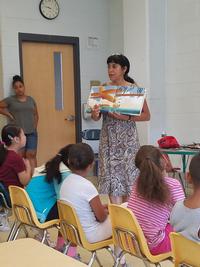 Linda Maldonado conducts a story time with a group of children. 